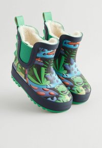 Bottes de pluie en caoutchouc avec un motif coloré de dinosaures et de feuillage, bleu marine avec des accents verts, intérieur doux et doublé, et semelles texturées.