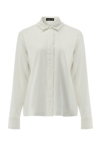 Weiße Bluse mit langen Ärmeln und Kragen, mit einer Knopfleiste und fransigen Kanten entlang der Knopfleiste für einen Texturkontrast.