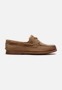 Chaussure bateau en cuir marron clair texturé avec détails en lacet, bout mocassin cousu, semelle en caoutchouc et logo Timberland sur le côté.
