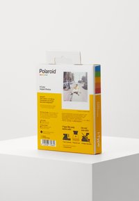 Polaroid I-Type film packaging, yellow with blue and red accents, features a photo window and text detailing film specifications and usage.