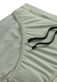 Peça de roupa verde-claro com um painel de rede texturizado, acabamento suave e detalhes em cordão preto para ajuste regulável.