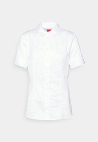 Chemise blanche à manches courtes avec un bouton, confectionnée en tissu lisse. Présente un col pointu, une coupe droite et des coutures latérales discrètes pour un look ajusté.