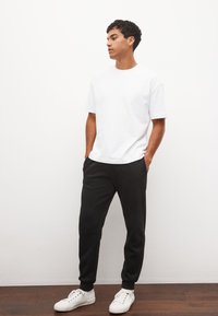 UNISEX - Spodnji deli trenirk - black