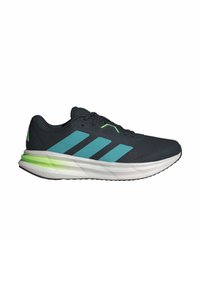 Baskets de sport avec une tige bleu marine foncé, des rayures bleu clair et des accents verts. Semelle blanche rembourrée avec le logo "CLOUDFOAM".