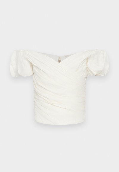 White off-the-shoulder blouse with puff sleeves, featuring ruched fabric and a crossover design at the front. Smooth texture, minimal detailing.