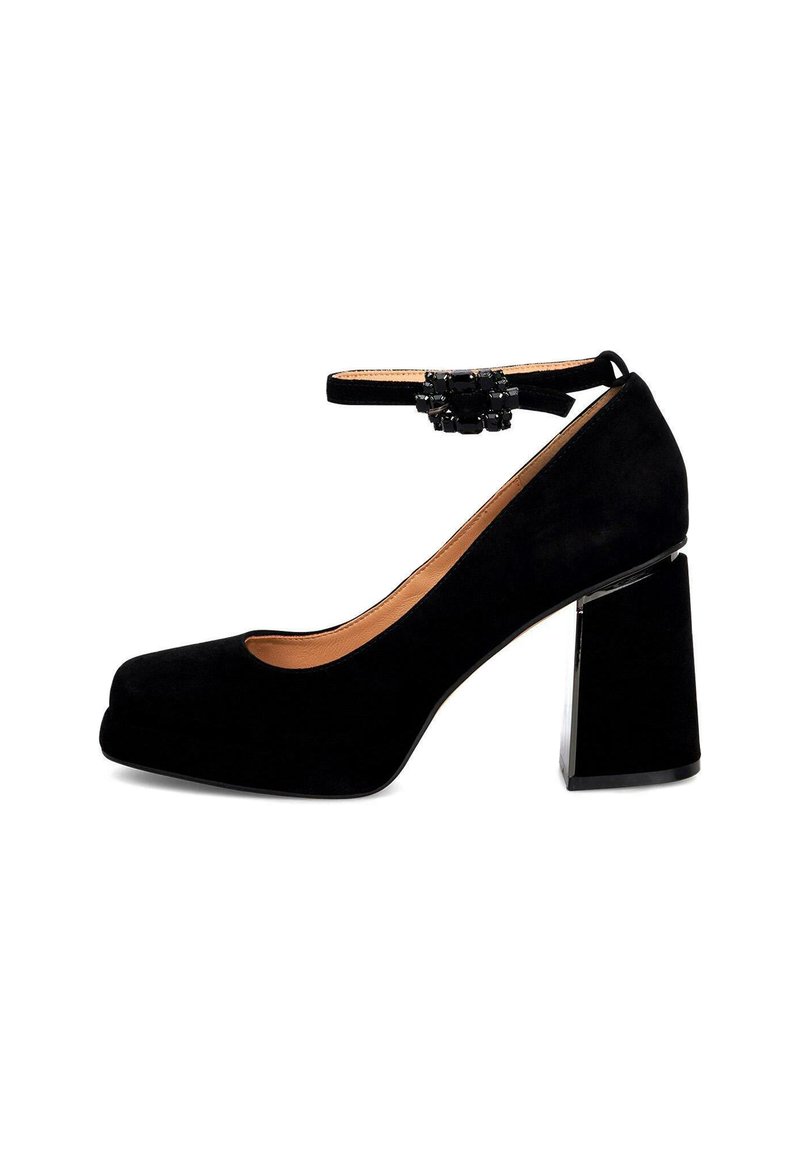 Tacchi a piattaforma in suede nero con un tacco a blocco chunky e cinturino alla caviglia, adornati con un accento decorativo in perline sul cinturino.