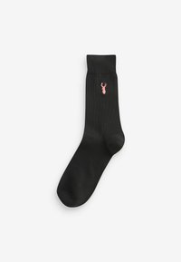 Chaussette noire avec une bordure côtelée, arborant un petit emblème de homard rose. Fabriquée en tissu doux, elle présente une texture lisse et une forme standard.