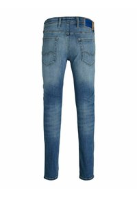 Tajta jeans i ljusblå denim. Har en midjehöjd, fem fickor och en läderlapp på bakre midjebandet.
