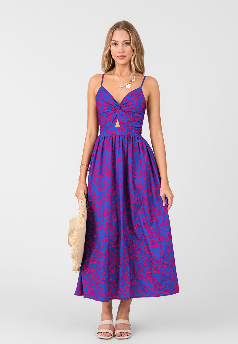 Maxikleid aus lila Stoff, verziert mit roten Blumenmustern, mit einem Herzausschnitt und einem Schlüsselloch-Ausschnitt in der Taille.