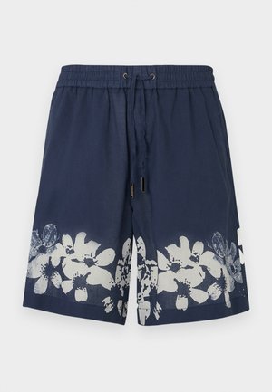 Marineblå badeshorts med elastisk midje, snor og hvitt blomstermønster ved kanten. Laget av lett stoff.