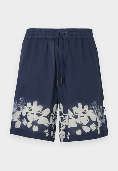 Shorts de bain bleu marine avec une ceinture élastique, un cordon de serrage et un motif floral blanc à l'ourlet. Fabriqués en tissu léger.