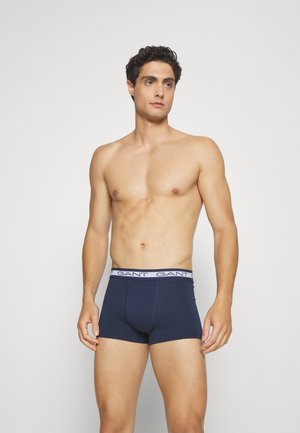 Navy blue cotton boxer briefs with a white elastic waistband featuring "GANT" logo. The design has a fitted shape for comfort and support.