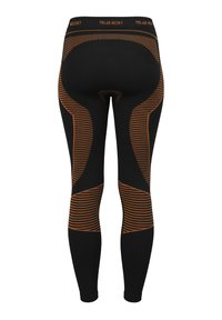Black leggings with orange striped patterns and accents, featuring a high waistband labeled "POLAR HUSKY." Made of stretchy fabric.