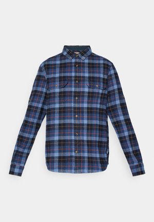 Flannel shirt featuring a blue, black, and red check pattern, button-up front, and two chest pockets. Long sleeves with button cuffs.