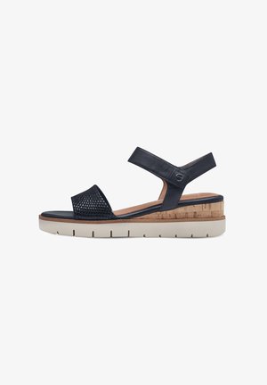 Navy blue sandal with perforated upper, cork wedge heel, and rubber sole featuring cushioning. Adjustable strap for secure fit.