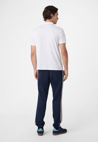 Fila BIELLA REGULAR TAPED - Verryttelyhousut - black iris