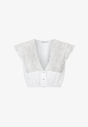 White crop top featuring a lace overlay on the bodice, short flutter sleeves, deep V-neck, and button closure at the front.