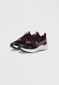 Pair of black and red Nike athletic shoes with white midsoles and blue outlined swoosh logos on white background.