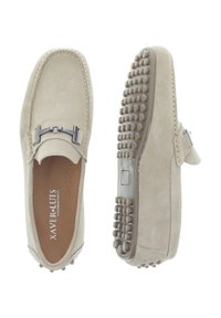 Beige suede loafers with a rounded toe, leather lining, metal accent on the upper, and textured rubber sole with small protrusions.