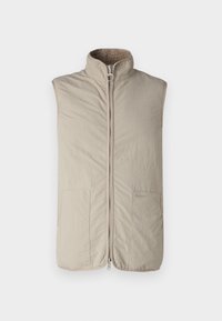 Beige sleeveless vest with a high collar, front zip closure, and two side pockets. Has a soft, textured lining and a subtle logo detail.