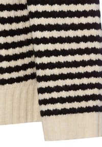 Knit sweater with black and cream horizontal stripes. The fabric appears fuzzy with ribbed cuffs and hem. Soft texture and warm design.