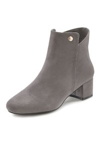 Grey suede ankle boot with a rounded toe, low block heel, and gold accent button detail on the side. Smooth texture and fitted design.