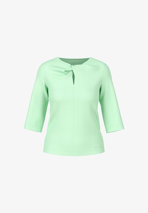 Light green, short-sleeve top with a keyhole neck design and a side knot detail. Smooth texture, fitted silhouette, and plain fabric.