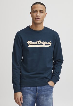 Marineblauw sweatshirt van katoen met een ronde hals. Voorzien van een groot, lichtgekleurde "Blend Original" logo in cursieve stijl op de voorkant.