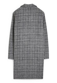 Harmaa ja musta ruudullinen takki, jossa on kaulus, pitkät hihat ja suora leikkaus. Valmistettu teksturoituneesta kankaasta, jossa on säännöllinen kuvio.