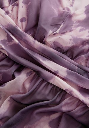 Tessuto stratificato in viola e malva, caratterizzato da una combinazione di motivi solidi e tie-dye, con una consistenza morbida e traslucida e dettagli arricciati.