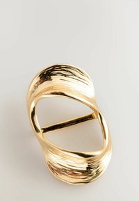 Gold-tone metal belt buckle with a wavy, textured design. Features an oval shape and a single horizontal bar for fastening.