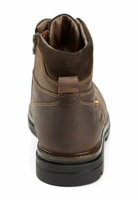 Brown leather ankle boot with a suede collar, side zipper, and contrasting stitching; textured, with a black rubber sole.