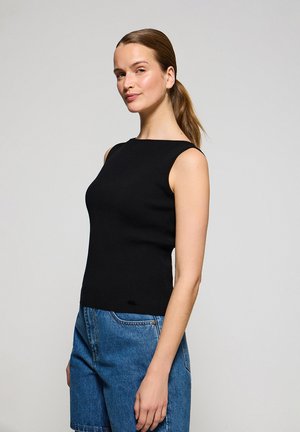 Zwart geribbeld mouwloos topje met een vierkante halslijn, gecombineerd met denim shorts. Het topje heeft een aansluitende pasvorm en lichte zijsplitten.