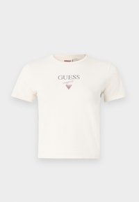 Valkoinen puuvillapaita lyhyillä hihoilla, pyöreällä kaula-aukolla, jossa on harmaalla painettuna "GUESS" ja punainen kolmion muotoinen logo keskellä.
