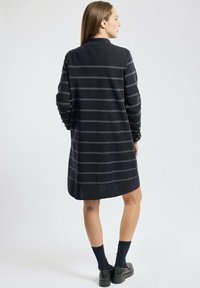 Robe en tricot bleu marine foncé avec des rayures grises, dotée d'un col et de manches longues. La conception présente une coupe droite et une longueur mi-cuisse.