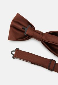 Brown textured bow tie with a black clasp and adjustable strap, featuring a smooth finish and a classic shape.