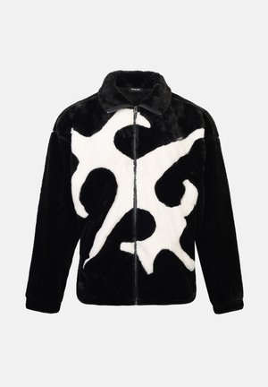 Black and white fleece jacket featuring a large abstract pattern, zip closure, collar, and ribbed cuffs. Soft texture with a relaxed fit.
