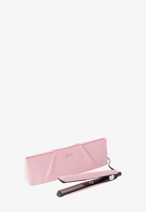Pink og sort glattejern med afrundede plader ved siden af matchende pink varmebestandig opbevaringspose på hvid baggrund.