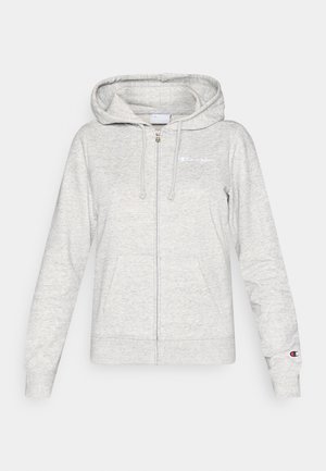 Casaco cinzento claro com fecho de correr, bolsos frontais, capuz com cordão e pequenos logótipos da Champion no peito e na manga esquerda.