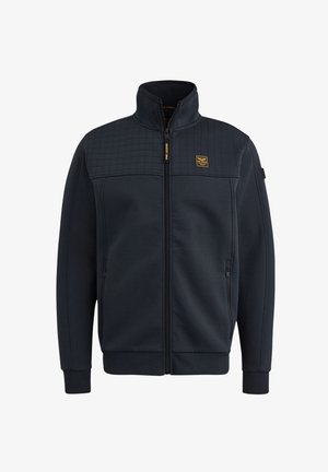 Marine blauwe ritsjack met een gewatteerd bovenpaneel, twee zijzakken en een klein logopatch op de borst; gemaakt van zacht, textuurstof.