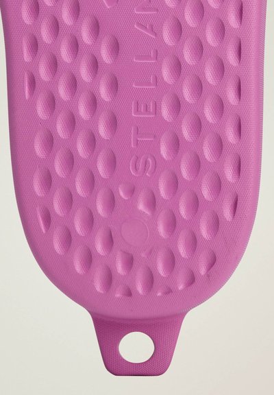 Purple silicone mat with a textured surface featuring raised, oval patterns and a loop for hanging at one end. The brand name "STELLAN" is embossed.