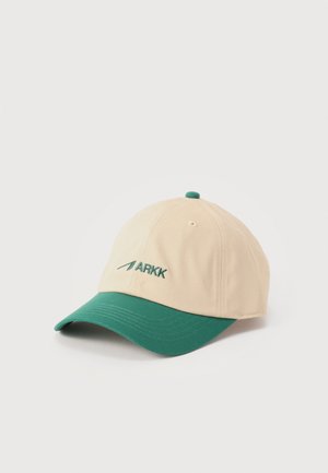 Beige baseball cap with a green curved brim and green "ARKK" logo embroidered on front panel.