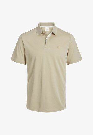 Beżowa koszulka polo z miękkiej tkaniny, z kołnierzykiem i krótkimi rękawami. Posiada kontrastujący akcent z siateczki oraz małe logo.