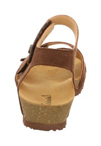 Brauner Wildledersandale mit Kork-Plateau, offenem Rückenteil und verstellbarem Riemen. Mit strukturierter brauner Sohle und weichem Lederfußbett.