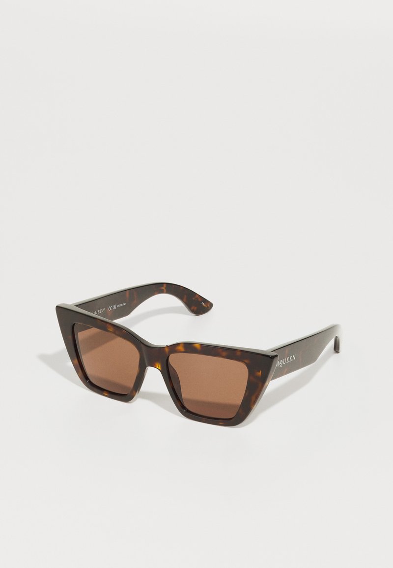 Brown tortoiseshell sunglasses with a square frame and dark brown lenses. Features the brand name on the temple in white lettering.