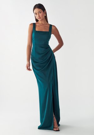 Teal satin evening gown with a square neckline, fitted bodice, draped detail, and thigh-high side slit, featuring a smooth texture.
