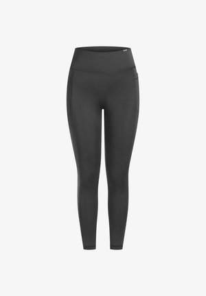 Leggings negros de talle alto, fabricados con tejido elástico, que cuentan con costuras planas y bolsillos laterales, diseñados para comodidad y movimiento.