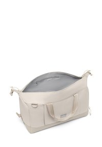 Beige Sporttasche aus strapazierfähigem Stoff mit einem glatten Innenfutter, ausgestattet mit zwei Griffen, einer Vordertasche und einem Reißverschluss.
