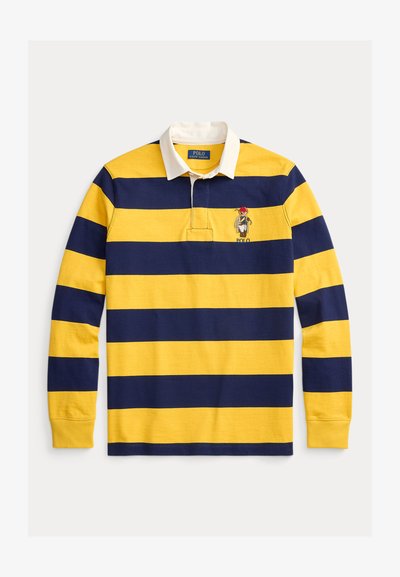 Ρουάκαι κίτρινη ριγέ ριγέ μπλούζα ράγκμπι με μακριά μανίκια, λευκό γιακά και κεντημένο λογότυπο στο στήθος. Κατασκευασμένη από βαμβακερό ύφασμα.