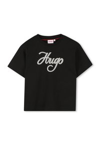 Crni pamučni majica s kratkim rukavima, s velikim sivim kurzivnim logotipom "Hugo" na prednjoj strani. Dizajn s okruglim izrezom, jednostavan i minimalistički stil.